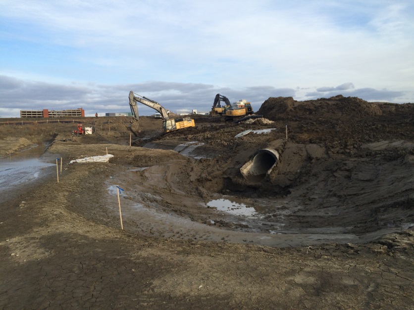 Construction crews complete work on the three inlets and one outlet for the stormwater pond. The inlets and outlets regulate the water level.